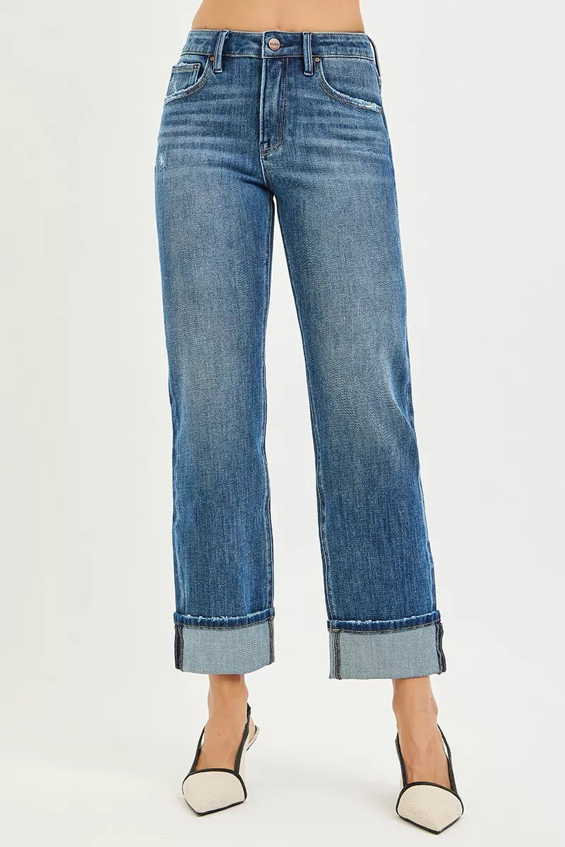 Dark blue straight-leg jeans with cuffed hems, button fly, and back pockets