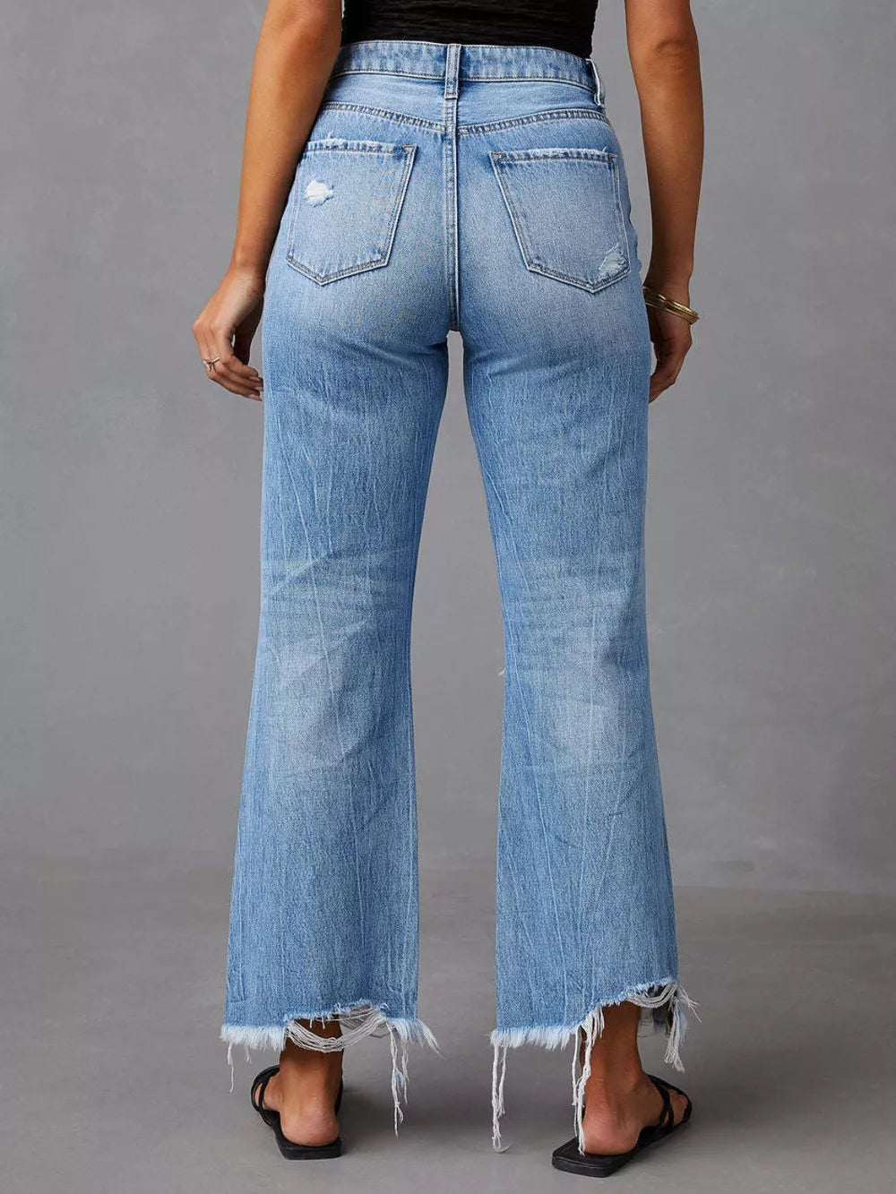 Light blue wide-leg jeans with back pockets and raw frayed hem