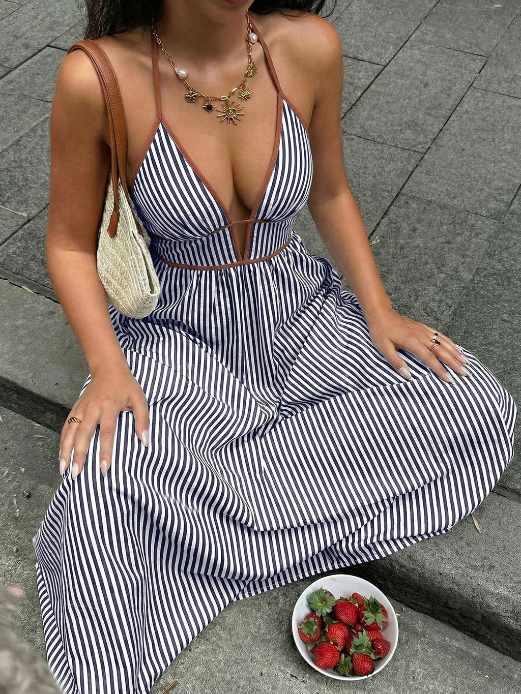 Navy-and-white striped halter maxi dress with crisscross waist and flowing skirt