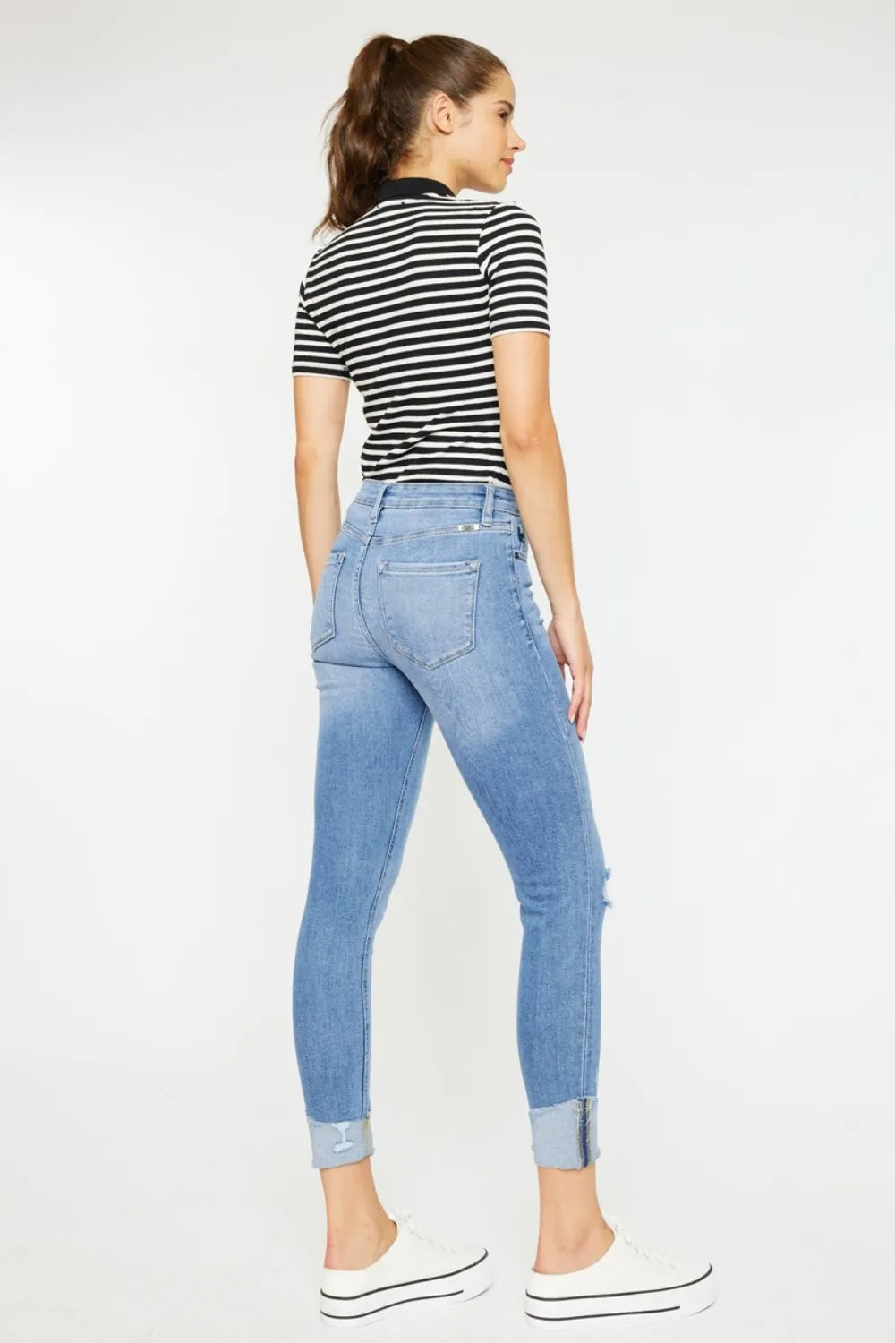 Light wash button-fly jeans with back-pocket distressing and skinny cropped legs