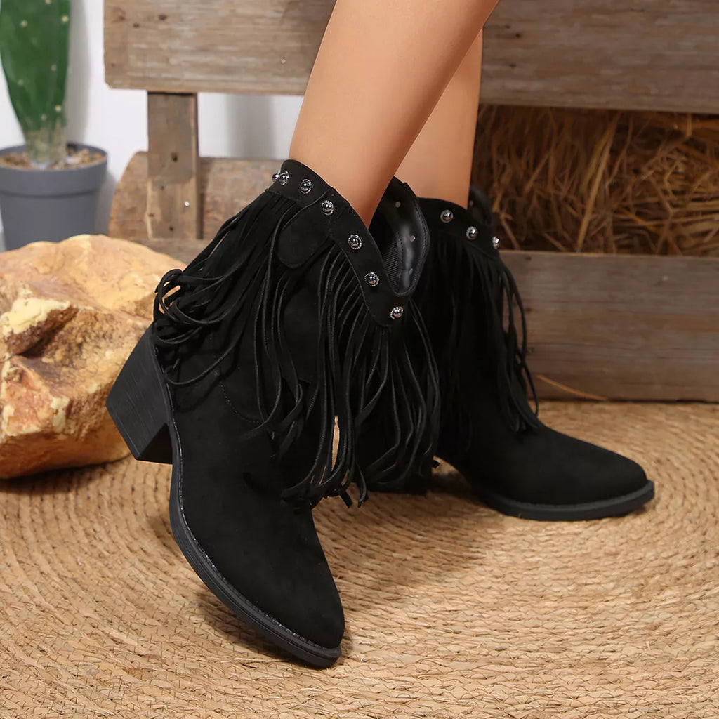 Black suede ankle boots with fringe, studded collar, and block heel