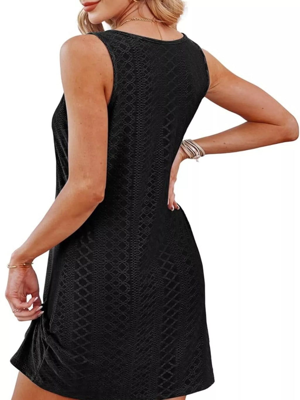 Black sleeveless tank dress with textured print and knotted hem detail.