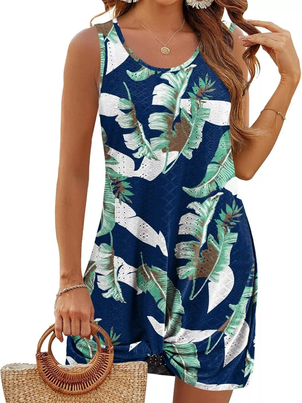 Navy sleeveless tank dress with tropical leaf print and knotted hem front.